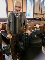 George Buckley standing proudly beside Bell No. 5 which was the one he usually rang.